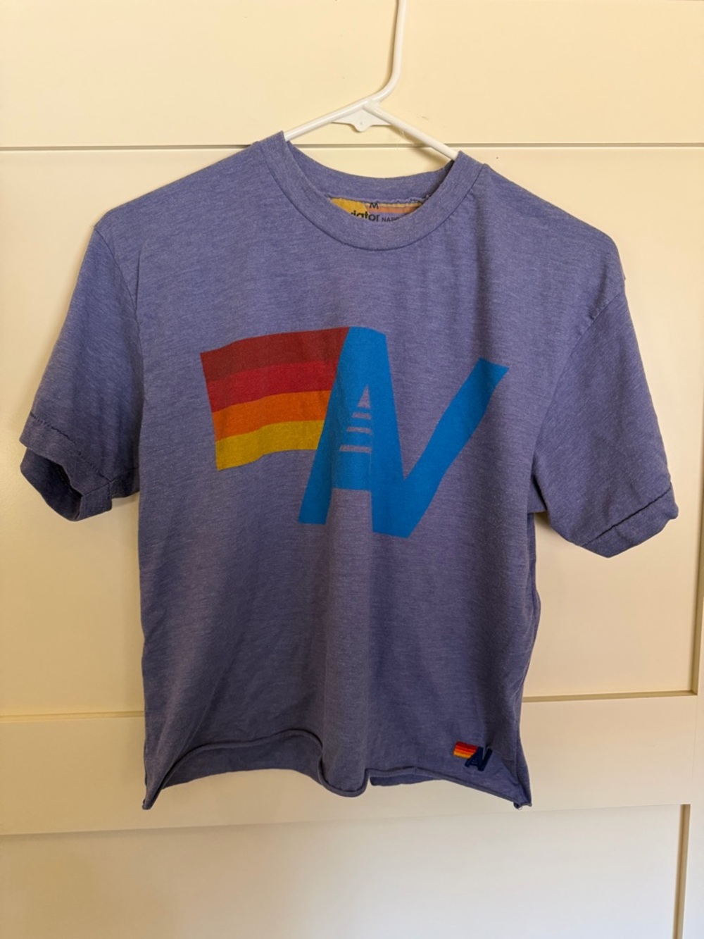 Aviator Nation Lavender Tee with Blue AV and Red-Orange-Yellow Flag